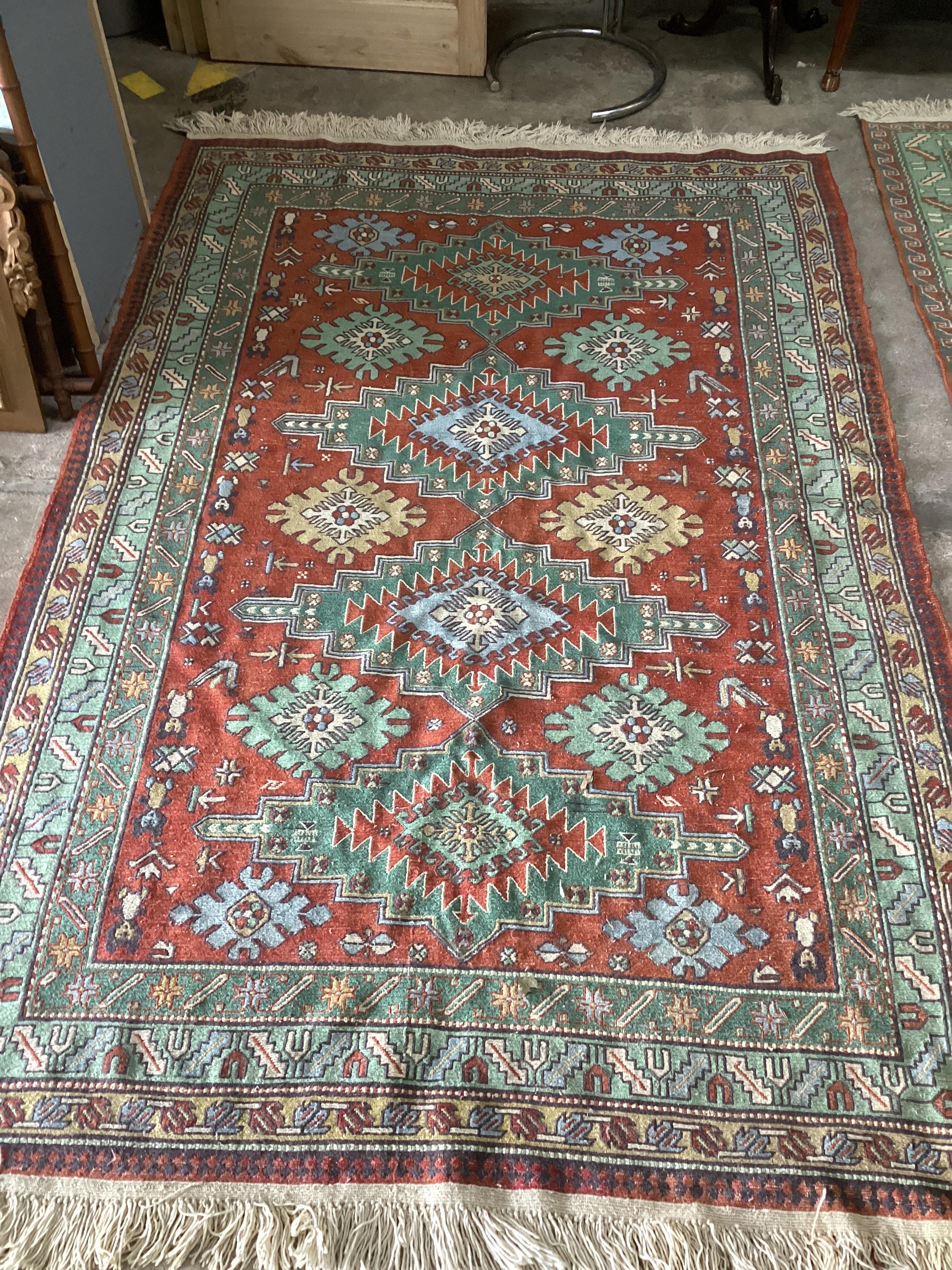 A Caucasian red ground carpet, 242 x 160cm